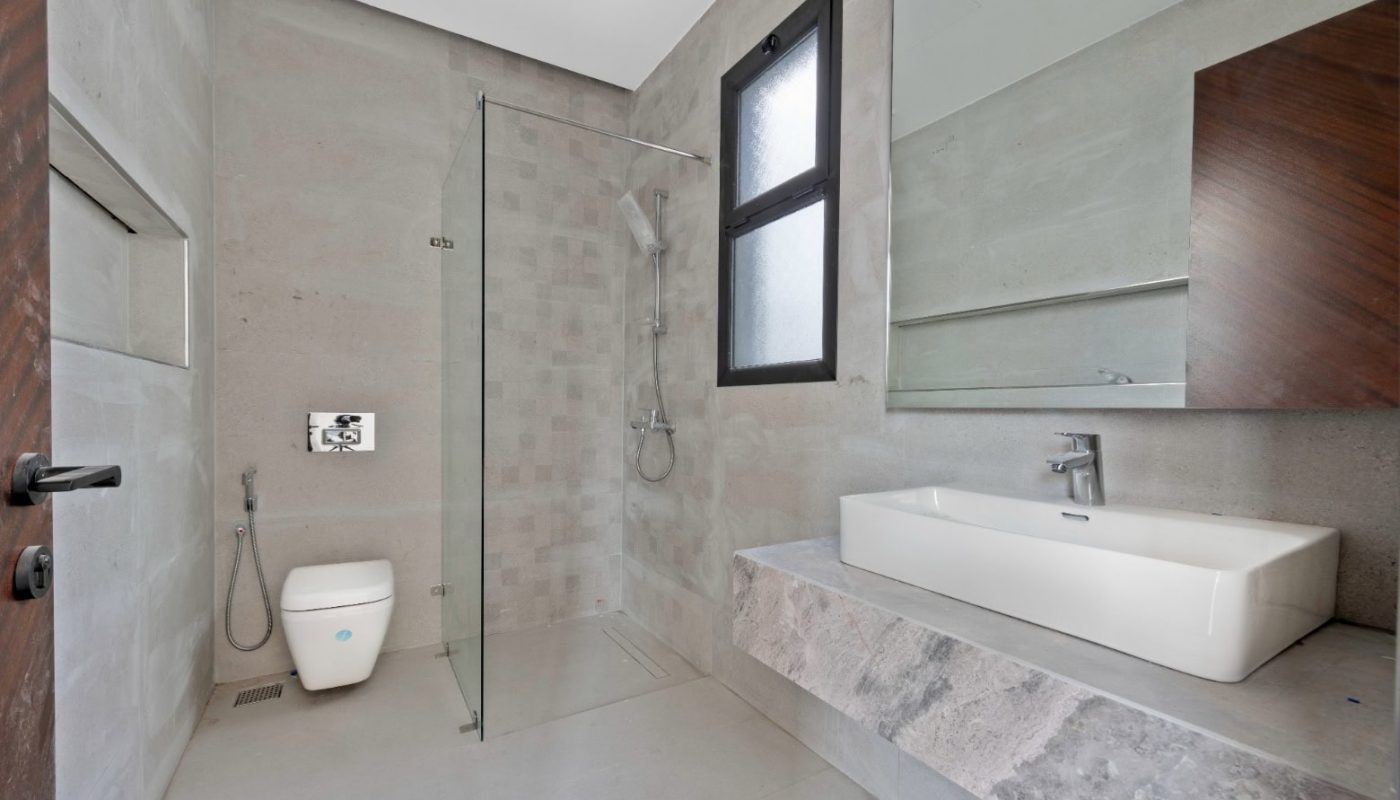 A modern bathroom with a sink and toilet.
