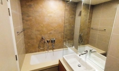 A luxury apartment for sale in Diyar Al Muharraq with a stunning bathroom featuring a bathtub, sink, and mirror.