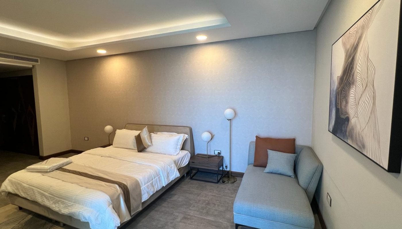 A luxurious bedroom with a comfortable bed and a cozy couch.