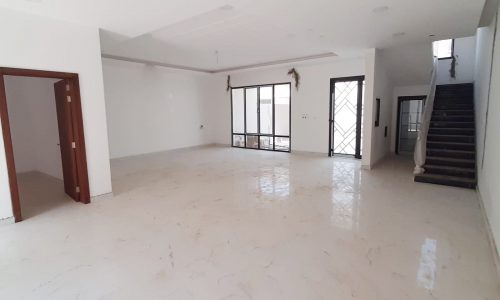 A luxurious 4BR villa for sale in Jid AL Haj with marble floors and stairs.