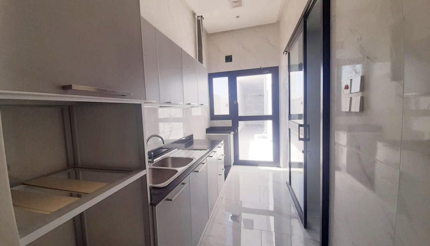 A stunning kitchen with stainless steel appliances and a glass door.