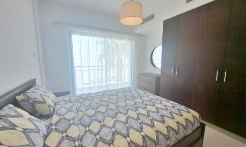 An apartment with a seafront view and a dresser.