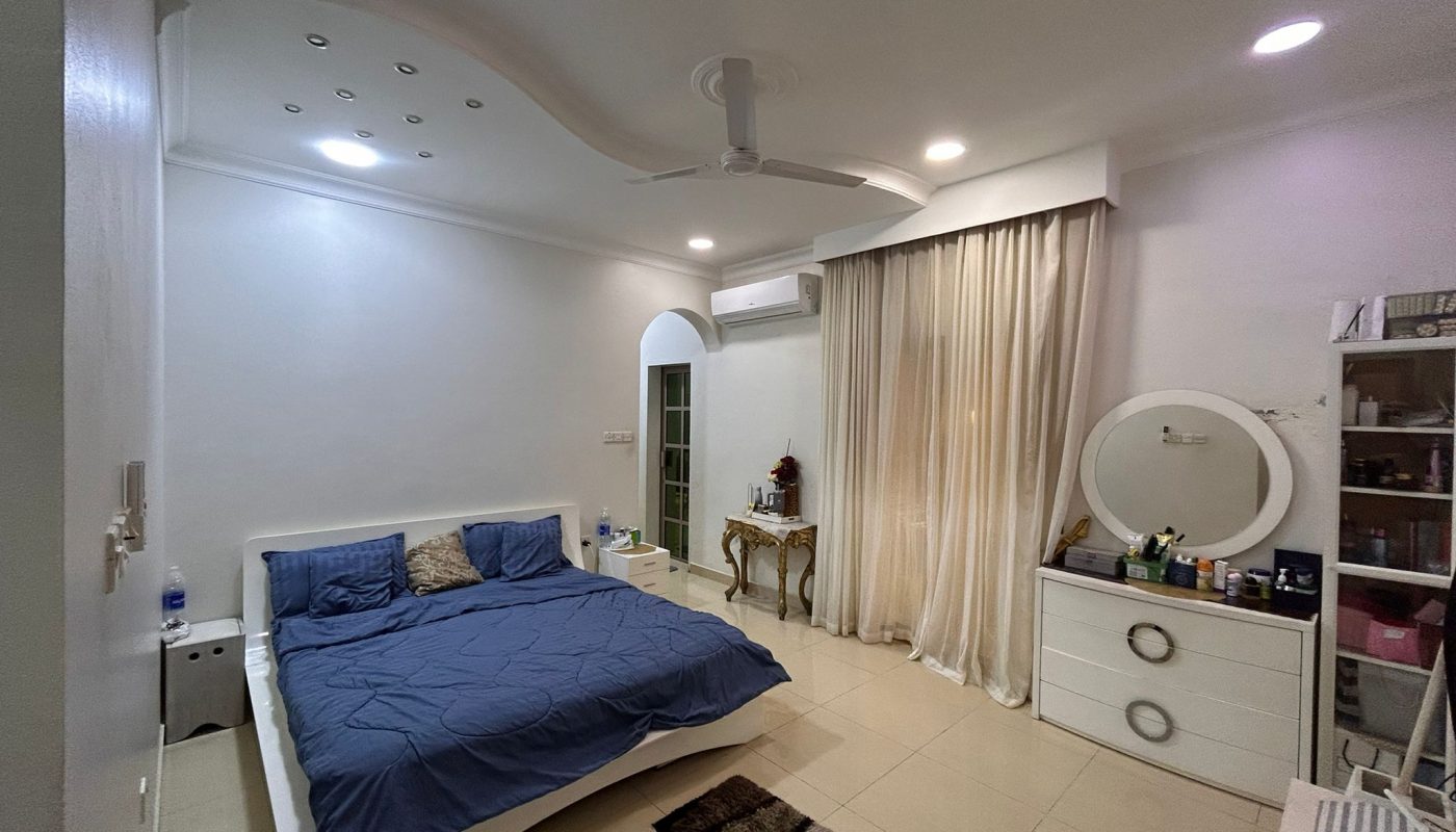 A modern bedroom with a double bed, blue bedding, white furniture, a round mirror, decorative rug, ceiling fan, and floor-to-ceiling curtains.