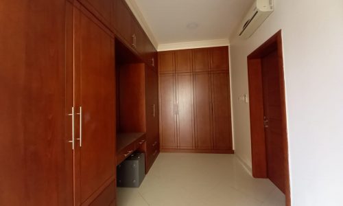 A room with wood cabinets and a door.