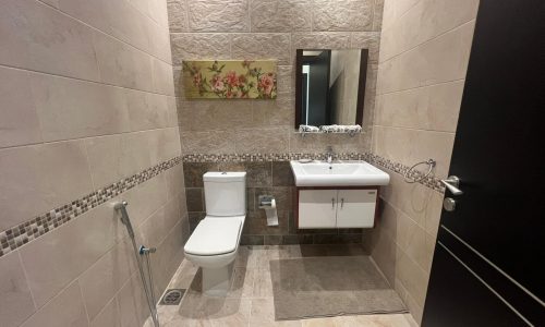 A modern bathroom with a toilet and sink.