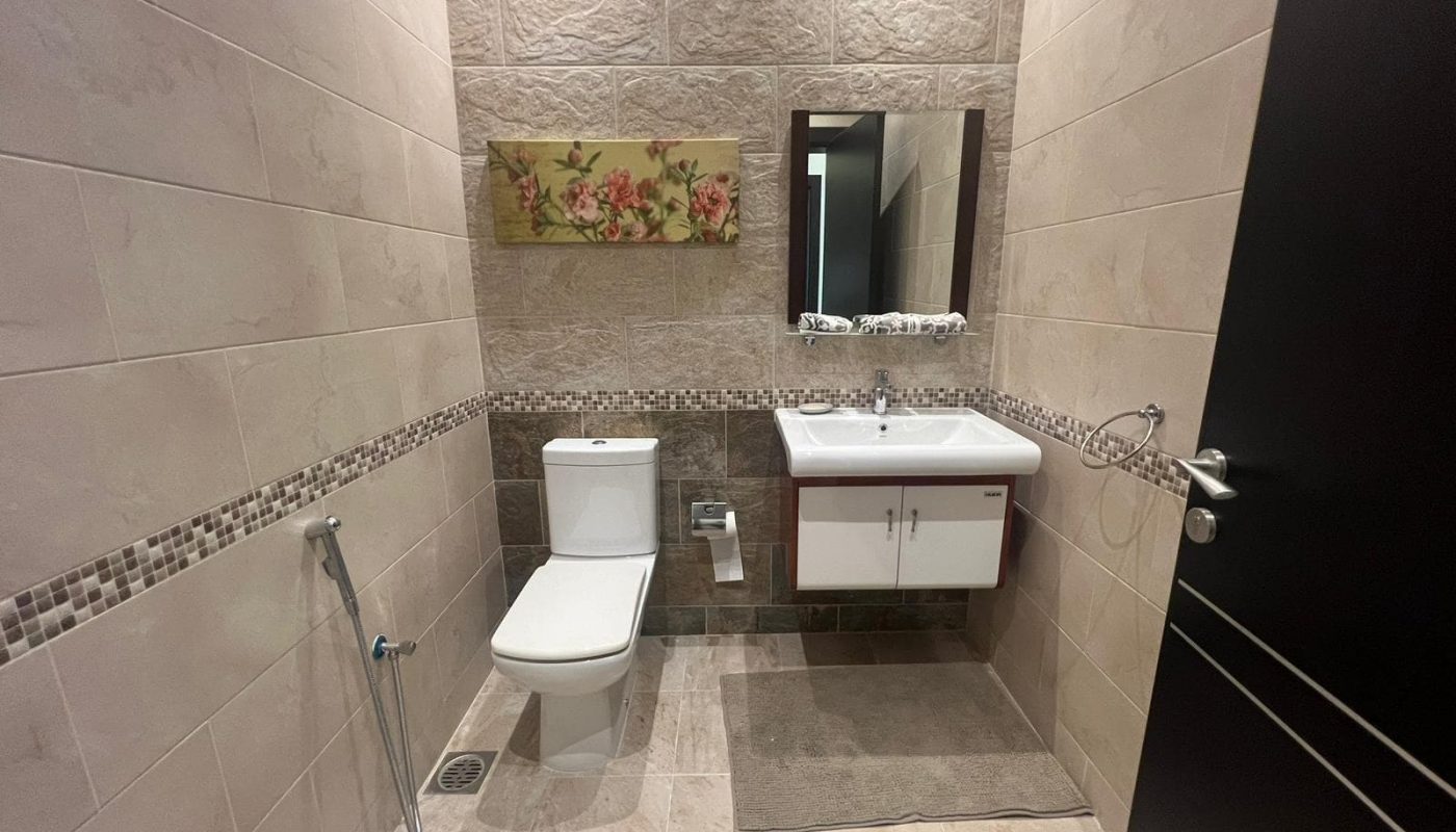 A modern bathroom with a toilet and sink.