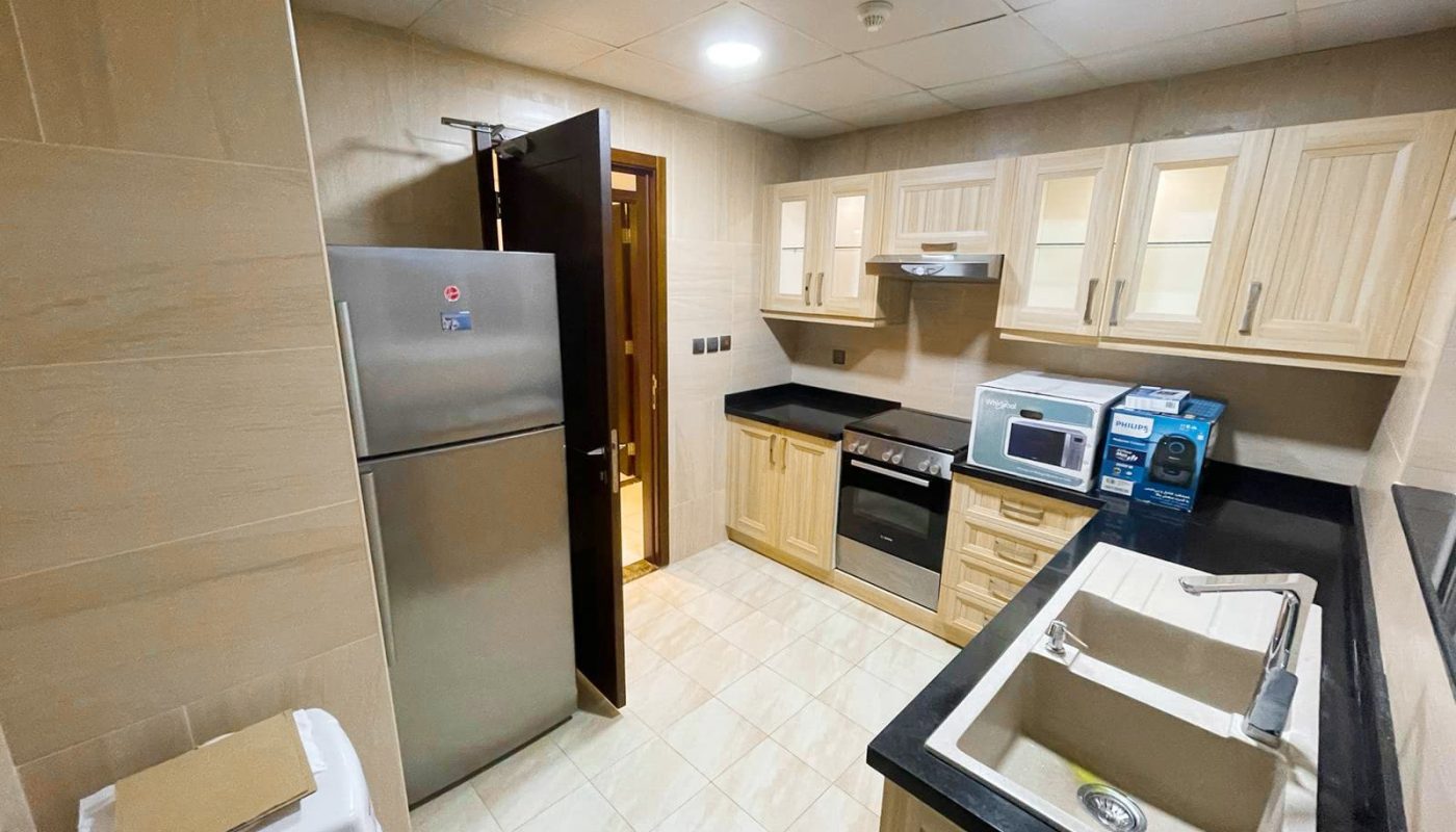 A kitchen with stainless steel appliances and a sink in a beautiful 1BR flat for rent.