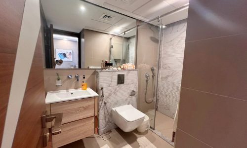 A luxurious bathroom with a toilet, sink and shower.