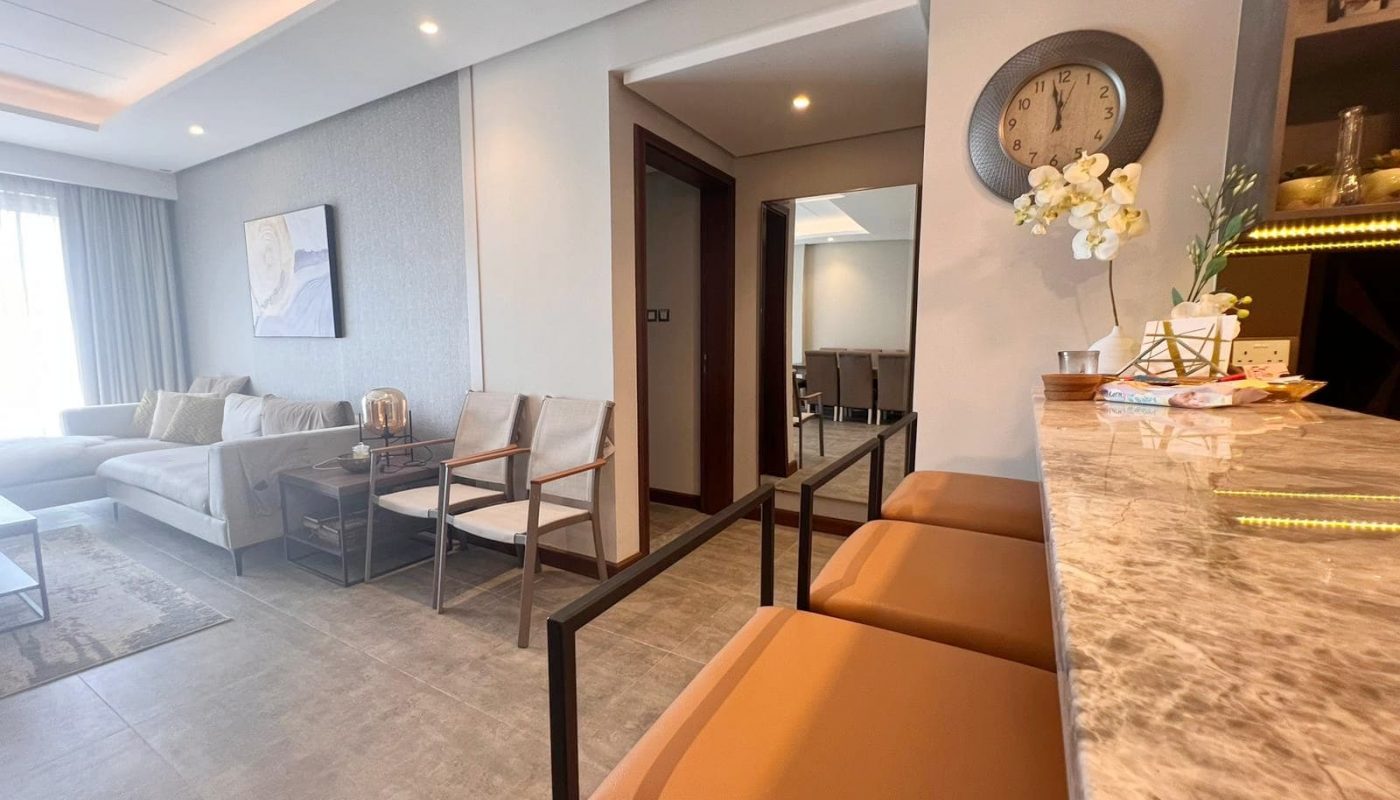 A luxurious living room with marble counter tops and chairs.