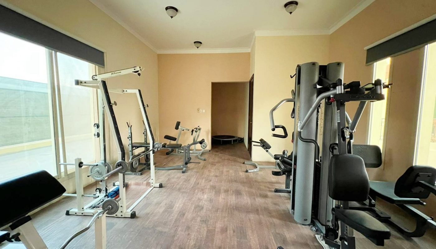 A gym room with an abundance of equipment.