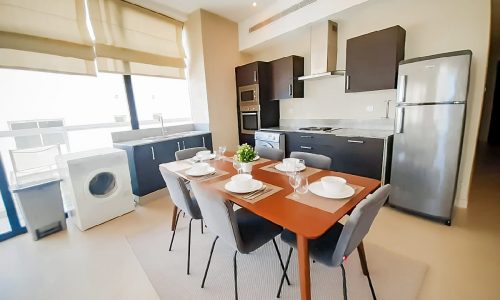 A fully furnished 2BR flat for rent in Juffair with a modern kitchen and dining area.