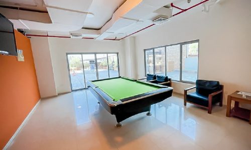 Luxury apartment with a pool table and chairs in Al Mahooz area.