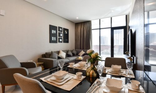 A modern dining table and chairs in a picturesque 2 bedrooms apartment for sale in Juffair.