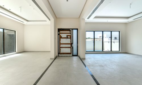 A luxurious empty room with sliding glass doors.