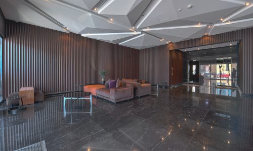 A black marble floor in a bright lobby.