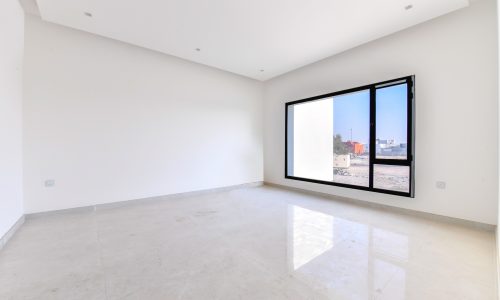 A large empty room with large windows and a view of the city, located in Saar.