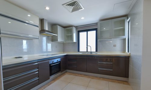 Spacious kitchen with a stove and oven.