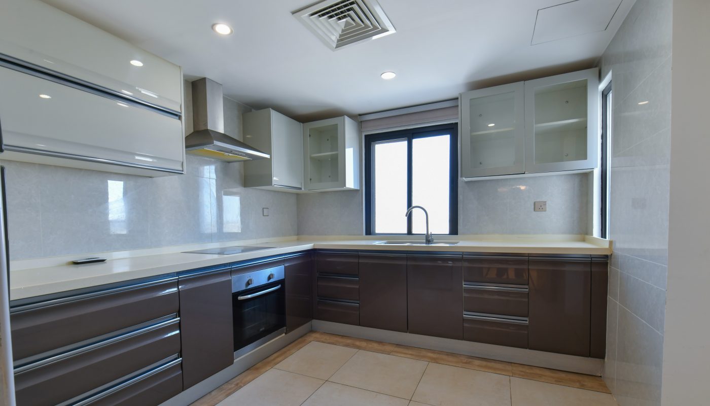Spacious kitchen with a stove and oven.