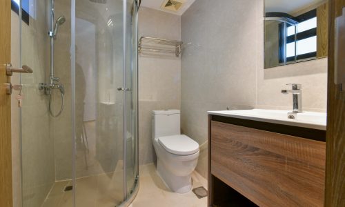 Stunning bathroom featuring a glass shower stall and toilet.