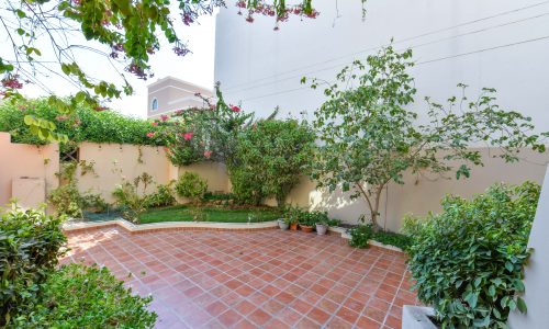 Stunning courtyard with plants and a tiled floor.