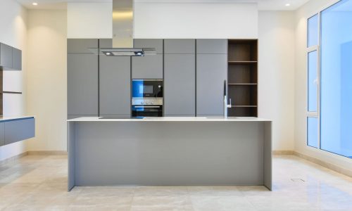 A kitchen with a microwave oven and a stove.