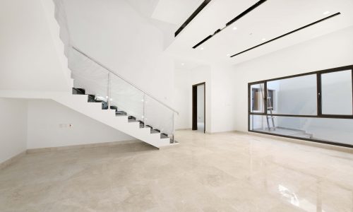 A luxurious villa for sale with a white room and staircase.