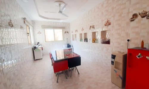 A luxurious kitchen with a red refrigerator and tiled walls.
