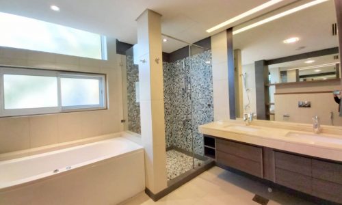 A modern bathroom with a large tub and sink in a Private Luxury Villa for Rent in Saar.