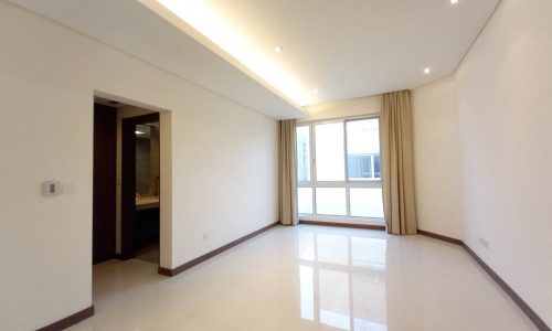 An empty private room in a luxury villa for rent, featuring white walls and floors.