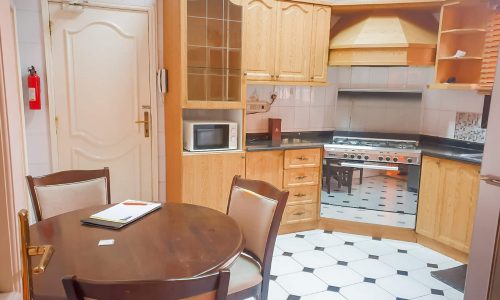 An elegant kitchen with a table and chairs.