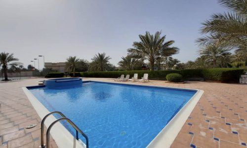 Luxury 4BR Villa for Rent in Janabiyah with swimming pool and palm trees.