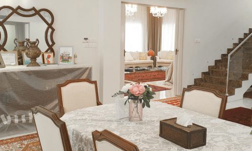 A luxurious dining room with a table and chairs.