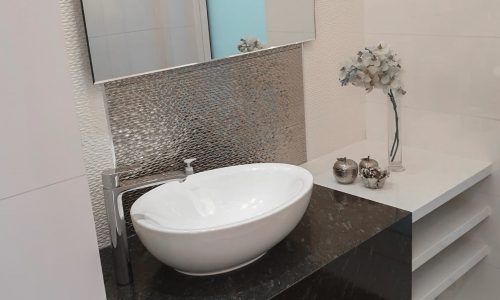 Luxury villa with a bathroom featuring a sink and mirror.