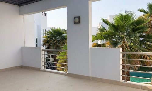 A lavish 4BR villa for rent in Hamala with a pool and terrace, offering a breathtaking view of palm trees.