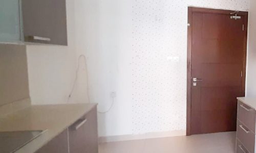 A modern kitchen with a sink and a door.