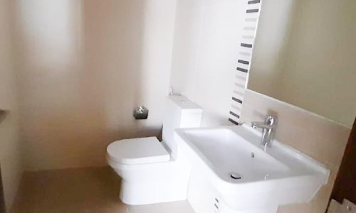 Modern, spacious 4 bedrooms flat for sale in Isa Town with a small bathroom including a toilet and sink.