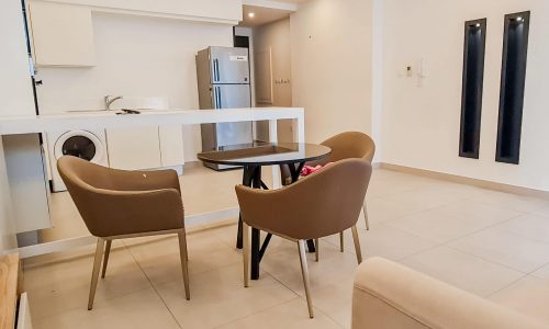 A modern apartment with a dining table and chairs available for rent in Juffair.