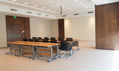 A luxurious conference room with wooden tables and chairs for rent in the diplomatic area.