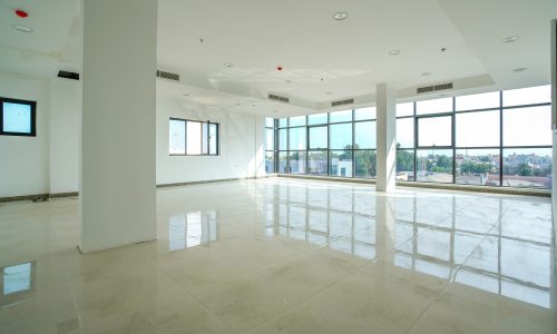 Luxury offices for rent with large windows and marble floors.