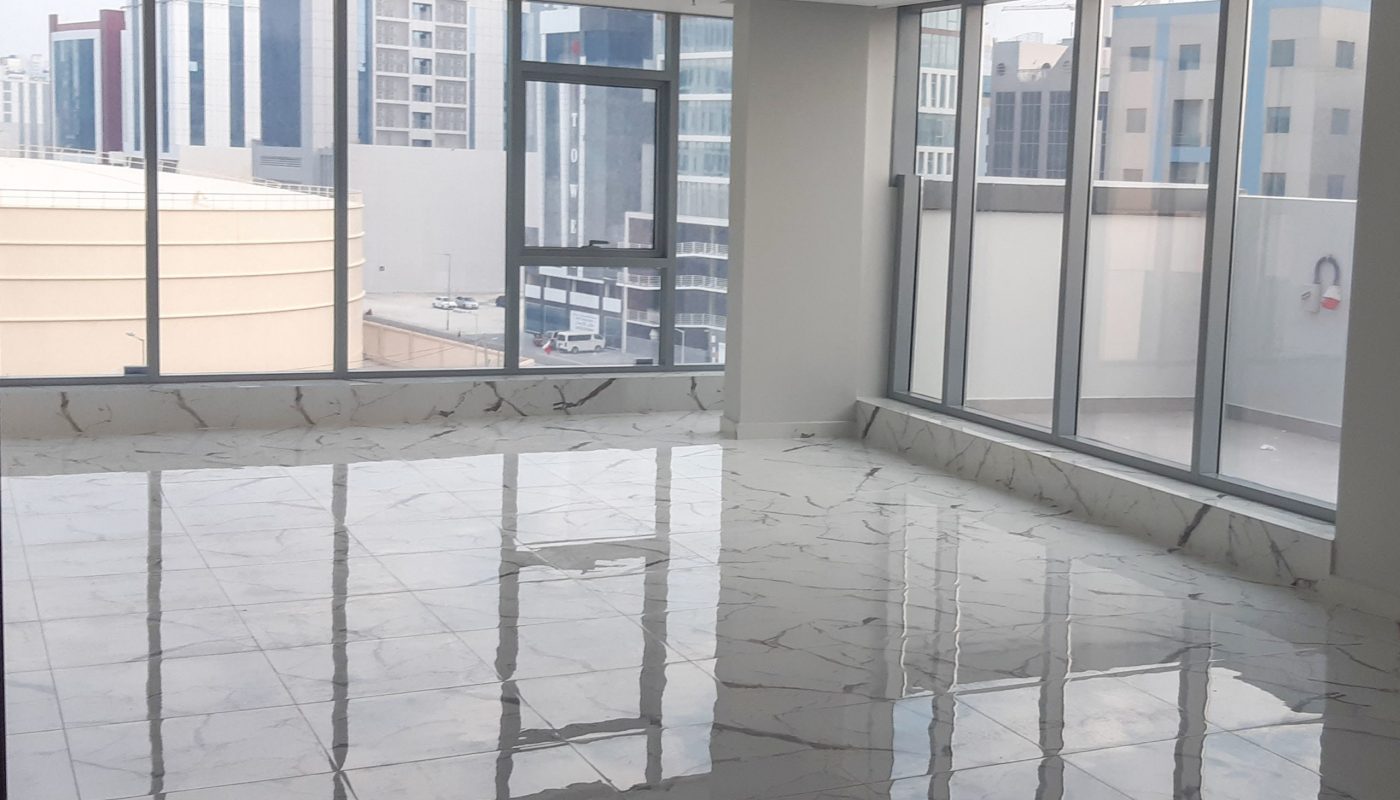 Luxury office space for rent with large windows overlooking a city.