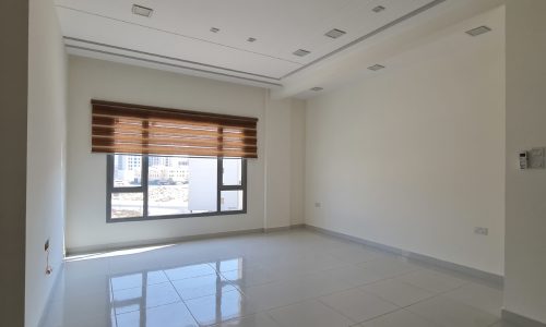 A 2BR room with white tile floors and a window.