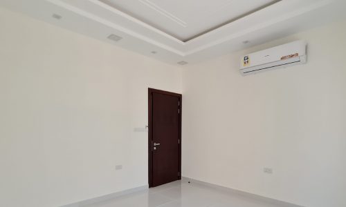 Neat office space with white walls and air conditioner available for rent.