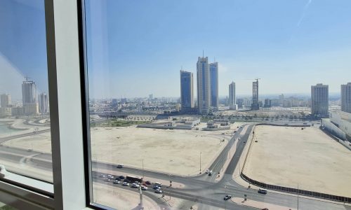 A view of an attractive city from the window of a Seef Area apartment.