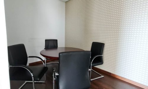 An attractive conference room for rent in Seef Area with black chairs and a wooden floor.