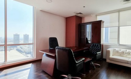 Attractive office space for rent in Bahrain's Seef area with large windows and a view of the city.