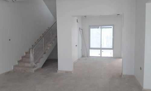 Brand new, spacious villa for sale in Al Maqsha featuring an empty room with stairs and white walls.