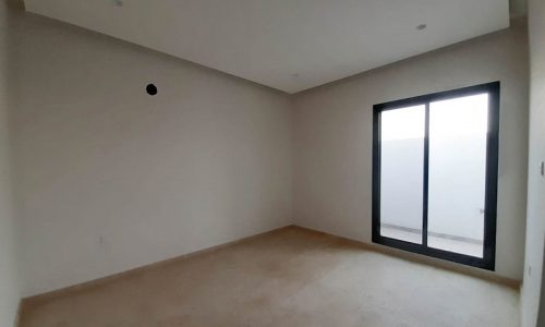 An ultramodern empty room with a sliding glass door.