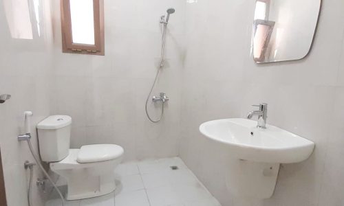 A commercial apartment for rent in Seef with a bathroom featuring a toilet, sink, and shower.