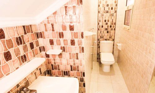 A small bathroom in a 7BR Wonderful Villa for Sale in Amwaj Island, with a toilet and sink.