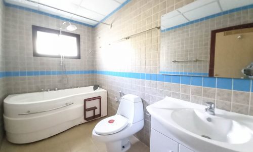 A wonderful villa in Saar with a bathroom featuring a toilet, sink, and blue tiled walls.